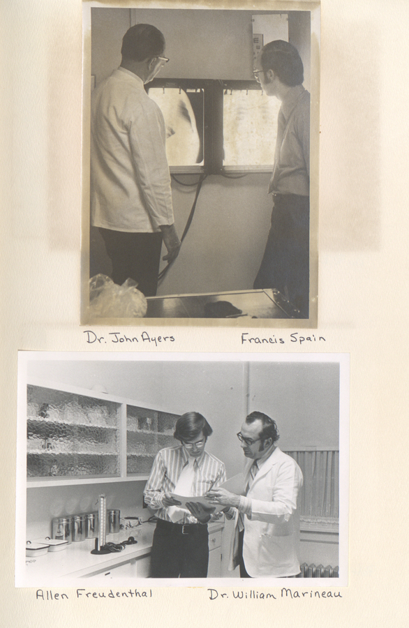 Photograph showing Dr. John Ayers and Francis Spain; Dr. William Marineau and Allen Freudenthal engaged in a discussion in a laboratory setting.