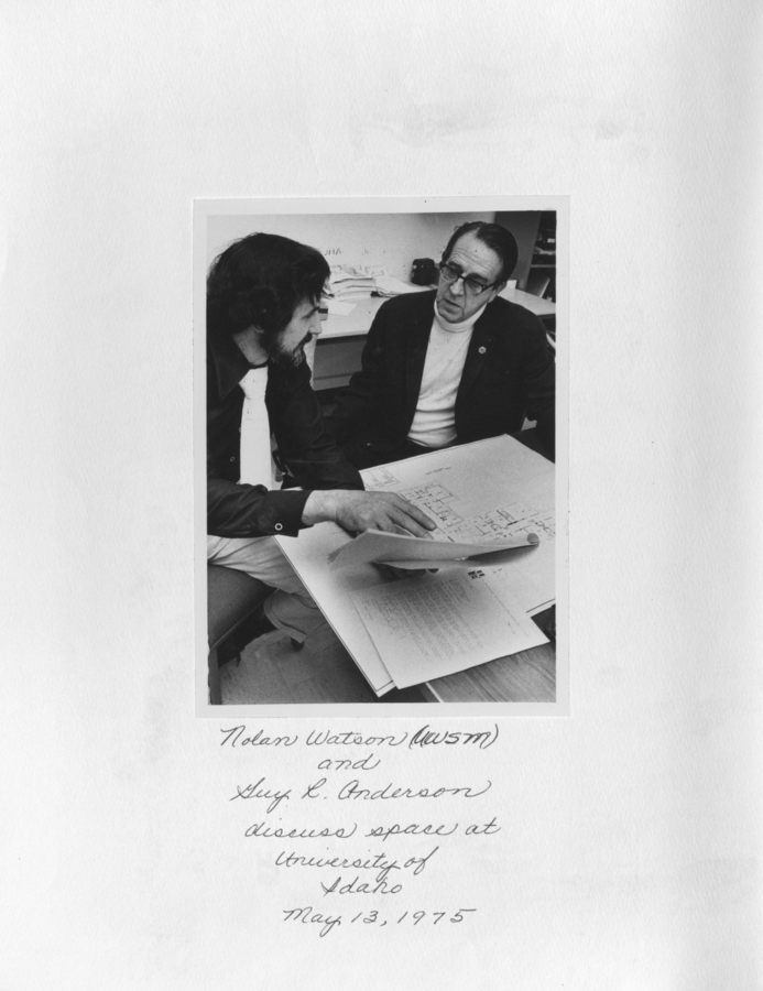 A photograph of Nolan Watson and Guy L. Anderson discussing space at the University of Idaho.